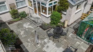 Aerial view of a patio featuring a table surrounded by chairs, showcasing an outdoor dining area